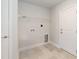 Laundry room with tile flooring, utility sink, and built in shelving at 56 Braddock Ct, Garner, NC 27529