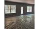 An unfinished living room featuring 3 large windows and a back door at 56 Braddock Ct, Garner, NC 27529