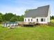 Lush backyard features a well-kept lawn, a wooden deck, and an above-ground swimming pool for outdoor enjoyment at 5608 Scottish Hills Dr, Holly Springs, NC 27540