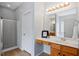 Bathroom featuring a vanity with lots of lights and a glass shower at 5608 Scottish Hills Dr, Holly Springs, NC 27540