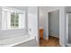 Bright bathroom featuring a soaking tub with a window and separate toilet room at 5608 Scottish Hills Dr, Holly Springs, NC 27540