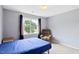 Bedroom featuring a recliner and blue sheets at 5608 Scottish Hills Dr, Holly Springs, NC 27540