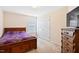 Bedroom with a wooden bed frame, and wooden dresser at 5608 Scottish Hills Dr, Holly Springs, NC 27540