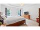 Primary bedroom features a tray ceiling, neutral color scheme and ample closet space at 5608 Scottish Hills Dr, Holly Springs, NC 27540