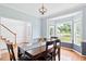 Elegant dining room with natural light and wooden floors perfect for Gathering gatherings at 5608 Scottish Hills Dr, Holly Springs, NC 27540