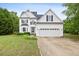 Charming two-story home with a well-manicured lawn and attached two car garage at 5608 Scottish Hills Dr, Holly Springs, NC 27540