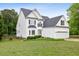 Charming two-story home with a well-manicured lawn and attached two car garage at 5608 Scottish Hills Dr, Holly Springs, NC 27540