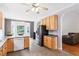 Spacious kitchen offering an eat-in island and stainless steel appliances at 5608 Scottish Hills Dr, Holly Springs, NC 27540