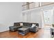 Spacious living room with hardwood floors, comfortable seating, and plenty of natural light at 5608 Scottish Hills Dr, Holly Springs, NC 27540