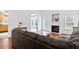 Living room showcasing a fireplace, and an arched doorway to a sunroom at 5608 Scottish Hills Dr, Holly Springs, NC 27540