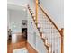 Carpeted staircase with wood trim leading to a spacious living room with a fireplace at 5608 Scottish Hills Dr, Holly Springs, NC 27540