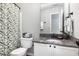 Bathroom with granite countertop, white cabinets, and decorative shower curtain at 5637 Yates Garden Ln, Raleigh, NC 27606