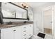 Bathroom with a large vanity, dual sinks, granite countertop and decorative mirror at 5637 Yates Garden Ln, Raleigh, NC 27606