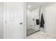 Bathroom with a glass shower, marble floors, and a white door at 5637 Yates Garden Ln, Raleigh, NC 27606