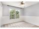 Cozy bedroom with a large window, carpet floors, and soft natural light at 5637 Yates Garden Ln, Raleigh, NC 27606