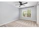Bedroom with a large window, neutral colors, and a ceiling fan at 5637 Yates Garden Ln, Raleigh, NC 27606