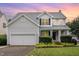 Charming two-story home with a manicured lawn, garage, and inviting entryway at 5637 Yates Garden Ln, Raleigh, NC 27606