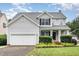 Charming two-story home featuring a well-maintained yard and attached two-car garage at 5637 Yates Garden Ln, Raleigh, NC 27606