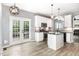 Updated kitchen featuring white cabinets, granite counters, and a center island with bar seating at 5637 Yates Garden Ln, Raleigh, NC 27606