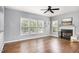 Bright living room with hardwood floors, fireplace, ceiling fan, and lots of natural light at 5637 Yates Garden Ln, Raleigh, NC 27606