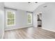 Spacious main bedroom with vaulted ceilings, hardwood floors, and bright windows providing scenic views at 5637 Yates Garden Ln, Raleigh, NC 27606