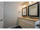 Bathroom featuring double sinks, granite countertop, and framed mirrors at 6101 Ricker Rd, Raleigh, NC 27610