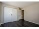 Bedroom with sliding barn doors, neutral walls, and wood-look floors at 6101 Ricker Rd, Raleigh, NC 27610