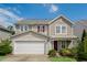 Charming two-story home with a well-maintained yard, attached garage, and craftsman-style details at 6101 Ricker Rd, Raleigh, NC 27610