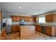 Bright kitchen with granite countertops, stainless steel appliances, and a central island at 6101 Ricker Rd, Raleigh, NC 27610