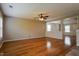 Spacious living room with hardwood floors, ceiling fan, and neutral wall colors at 6101 Ricker Rd, Raleigh, NC 27610