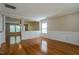Entryway with hardwood floors, white wainscoting, and an open view to other living spaces at 6101 Ricker Rd, Raleigh, NC 27610