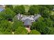Stunning aerial view of estate home surrounded by mature trees and greenery overlooking the golf course at 6510 New Market Way, Raleigh, NC 27615