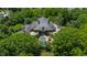 Expansive home with an in-ground pool is surrounded by mature landscaping on a private lot at 6510 New Market Way, Raleigh, NC 27615