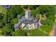 Stunning aerial view of estate featuring an in-ground pool, manicured landscaping and stone exterior finishes at 6510 New Market Way, Raleigh, NC 27615