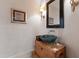 Unique bathroom featuring textured walls, a wooden base sink, and a round green sink at 6510 New Market Way, Raleigh, NC 27615