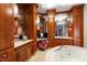 Bright bathroom featuring a jacuzzi tub, elegant cabinets, and marble countertop at 6510 New Market Way, Raleigh, NC 27615