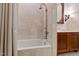 Bright bathroom featuring a bathtub with shower and a marble topped vanity at 6510 New Market Way, Raleigh, NC 27615