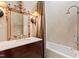 Elegant bathroom with marble counters, traditional mirror, and vintage-style fixtures at 6510 New Market Way, Raleigh, NC 27615