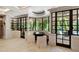 Breakfast nook with stone flooring, rounded windows, and a view of the backyard swimming pool at 6510 New Market Way, Raleigh, NC 27615