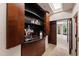 Coffee bar with espresso machine and storage cabinets adjacent to hallway with doors and natural light at 6510 New Market Way, Raleigh, NC 27615