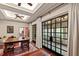 Dining room with hardwood floors, French doors, ceiling fan, and a vintage-style table with colorful chairs at 6510 New Market Way, Raleigh, NC 27615