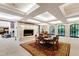 Elegant dining room with fireplace, round table, and detailed ceiling for refined gatherings at 6510 New Market Way, Raleigh, NC 27615