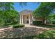 Elegant home exterior with a circular driveway and lush green landscaping at 6510 New Market Way, Raleigh, NC 27615