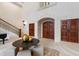 Impressive foyer featuring staircase, table, and stone archway offers a luxurious and inviting space at 6510 New Market Way, Raleigh, NC 27615