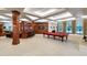 Spacious game room with custom bar, coffered ceilings, and ample natural light from large windows at 6510 New Market Way, Raleigh, NC 27615