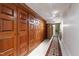 Hallway featuring wood closets with stone walls and rug down the hall at 6510 New Market Way, Raleigh, NC 27615