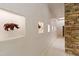Hallway featuring unique wall niches with artful animal sculptures and stone accent wall at 6510 New Market Way, Raleigh, NC 27615