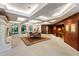A formal living room features stone floors, wooden accent wall, fireplace, and a dining area at 6510 New Market Way, Raleigh, NC 27615