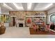 Elegant living area with stone wall, fireplace, hardwood floors, and recessed lighting at 6510 New Market Way, Raleigh, NC 27615