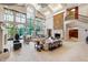 Bright living room with large windows, neutral furniture, and a striking tapestry offers elegant comfort at 6510 New Market Way, Raleigh, NC 27615